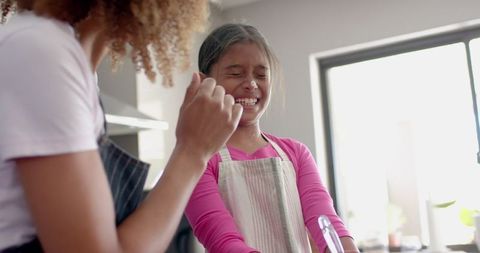 Mother and Daughter Enjoy Fun Baking Time in Kitchen