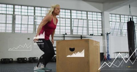 Female athlete performing box jump with fitness analytics overlay in bright industrial gym