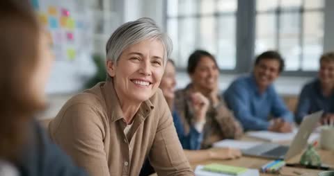 Senior Professional Smiling During Business Meeting