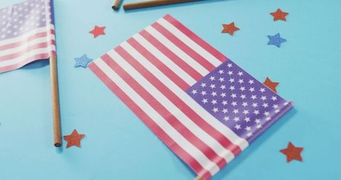 American flags and stars on blue background celebrating patriotism