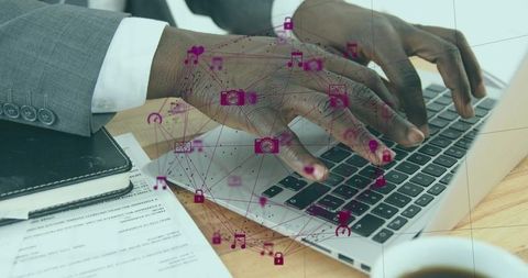 Typing hands on laptop with magenta digital network overlay boosting business productivity