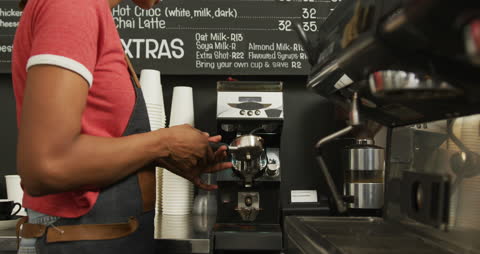 Barista Brewing Coffee in Modern Cafe