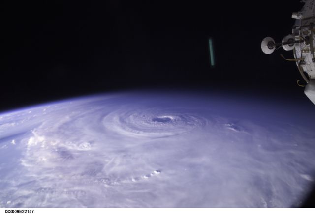 This captivating view of Hurricane Ivan from the International Space Station shows the massive storm from space. The image captures the swirling clouds and the hurricane's eye, offering a unique perspective on natural disasters. This image is ideal for use in educational materials, climate change discussions, meteorological studies, and illustrating the power and scale of Earth’s weather systems.
