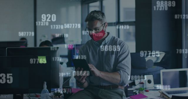 Businessman Wearing Red Mask Working on Tablet in Office with Digital Data Overlay - Download Free Stock Images Pikwizard.com