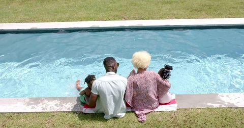 Family relaxing by poolside enjoying summer moments