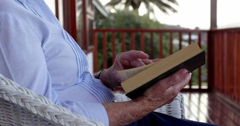 Senior Woman Relaxing with Book on Tranquil Balcony - Download Free Stock Images Pikwizard.com