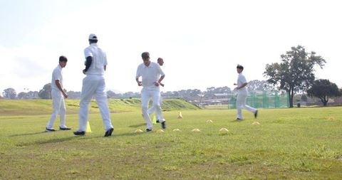 Cricket Players Training with Agility Drills on Field