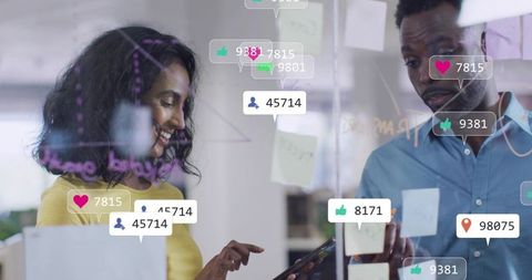 Collaborative team brainstorming on glass board with digital metrics and sticky notes
