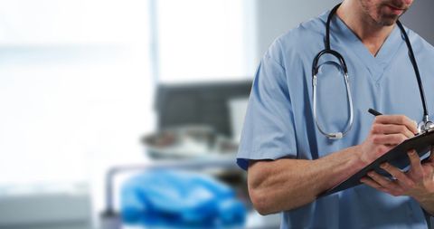 Male Doctor Writing Patient Notes in Hospital Ward - Download Free Stock Images Pikwizard.com