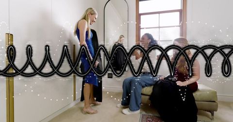 Woman Trying On Blue Dress and Clear Heels While Friends Offer Fashion Advice in Boutique