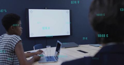 Business Team Analyzing Data on Screen in Modern Office Setting