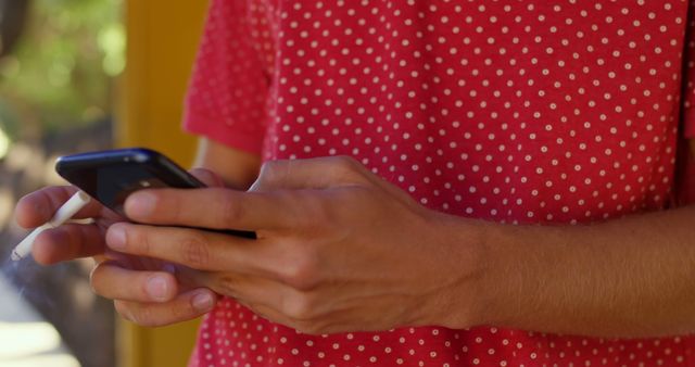 Person Texting on Smartphone While Holding Cigarette - Download Free Stock Images Pikwizard.com