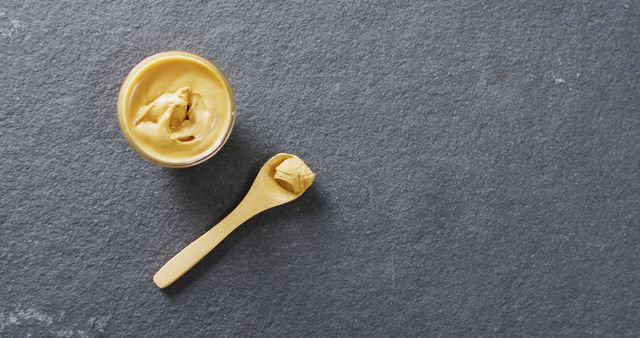 Close-Up of Creamy Peanut Butter in Small Wooden Spoon and Bowl on Slate Background - Download Free Stock Images Pikwizard.com