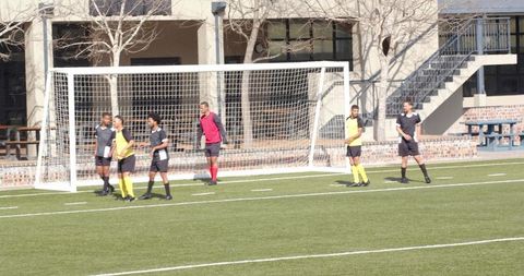 Soccer Players Coordinating in Team Practice Session on Field