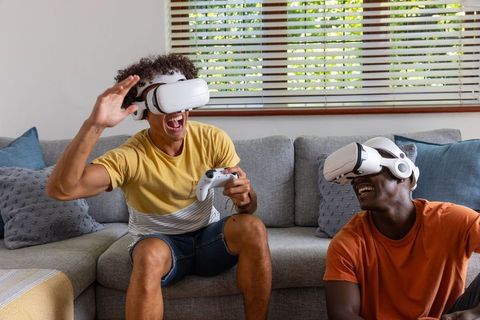 Friends Laughing and Gaming with Virtual Reality Headsets