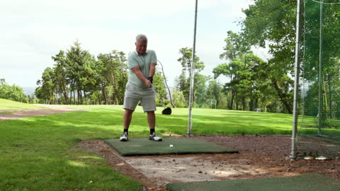 Man Practicing Golf Swing on Green Course Focusing on Technique