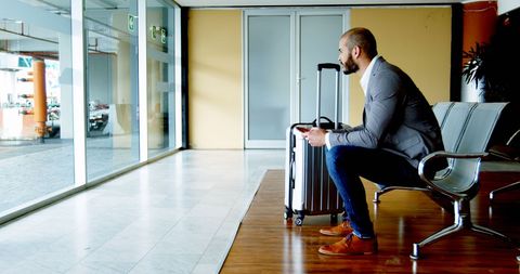 Businessman Traveling with Luggage in Airport Lounge
