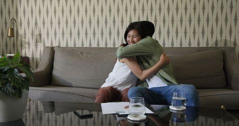 Couple Embracing on Sofa During Romantic Home Moment