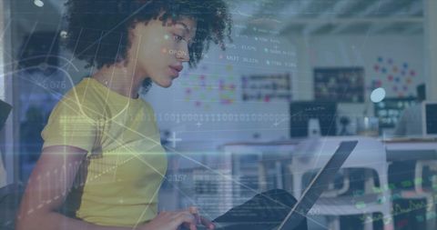 Biracial businesswoman analyzing data with laptop in modern office
