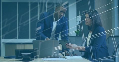 Business Professionals Analyzing Digital Tablet in Modern Office