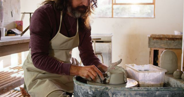 Male Craftsperson Working on Pottery Wheel in Artisan Studio - Download Free Stock Images Pikwizard.com