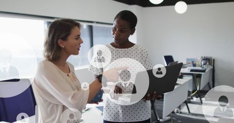 Diverse Women Discussing Business Strategy with Laptop in Modern Office - Download Free Stock Images Pikwizard.com