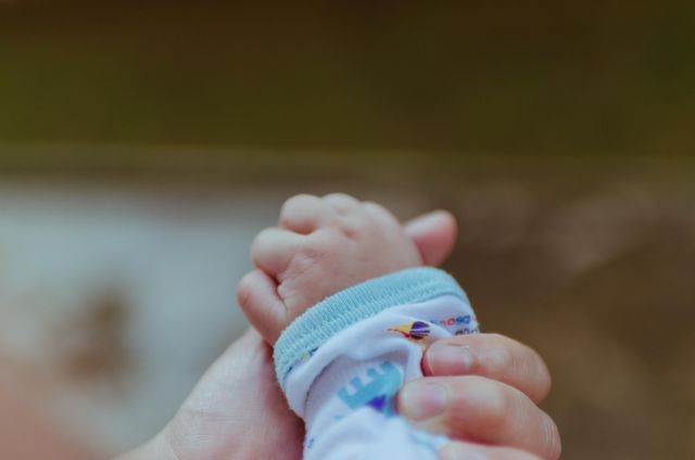 Newborn Hand Holding Parent Finger in Heartwarming Bond - Download Free Stock Photos Pikwizard.com