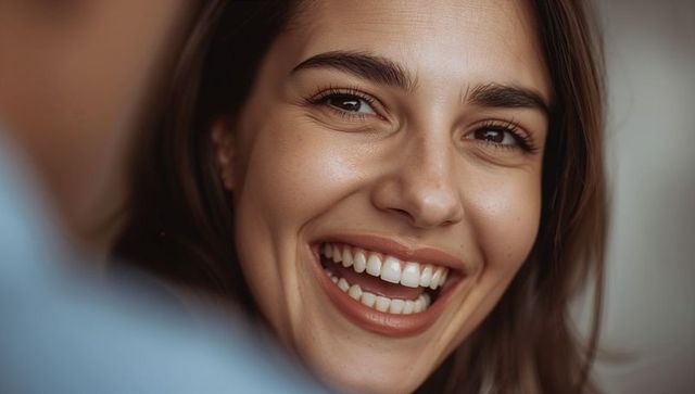 Smiling woman in casual attire experiencing warm connection