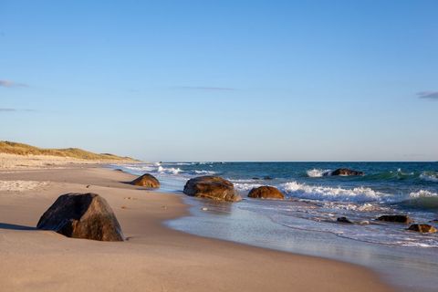 Serene Coastal Beach with Rocks at Sunset