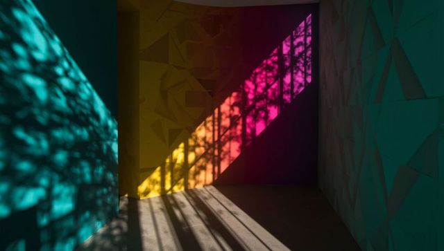 Abstract light patterns creating colorful shadows in modern art gallery