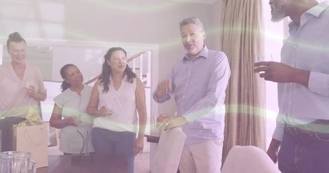 Multigenerational friends gathering at home sharing wine, gifts and casual conversation