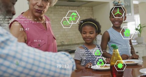 Multigenerational family sharing pancake breakfast with green eco technology overlays