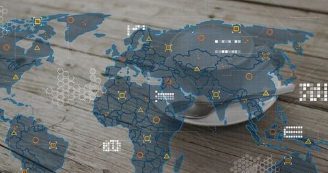 Coffee cup on rustic wood table with translucent world map and digital analytics overlay