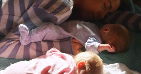Peaceful Mother Nurturing Bond with Twin Newborns - Download Free Stock Images Pikwizard.com