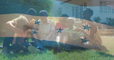Multigenerational family gathering on sunlit lawn with transparent flag overlay