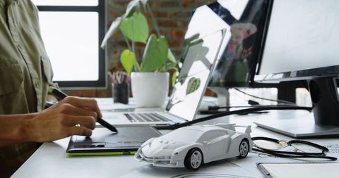 Automobile engineer designing with graphics tablet in modern office