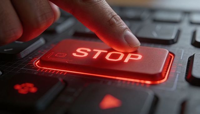 Pressing red stop key on backlit keyboard for emergency shutdown and cybersecurity control