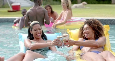 Diverse Group of Friends Relaxing at Vibrant Summer Pool Party - Download Free Stock Images Pikwizard.com