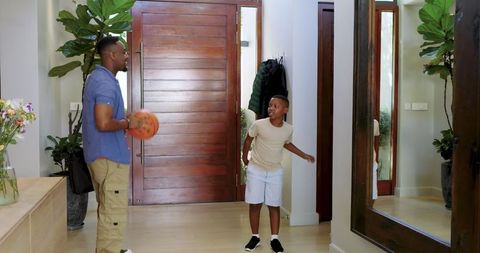 Family Bonding Indoors with Father and Son Playing Basketball