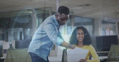 Team reviewing printed report with augmented reality overlay, smiling coworkers collaborating