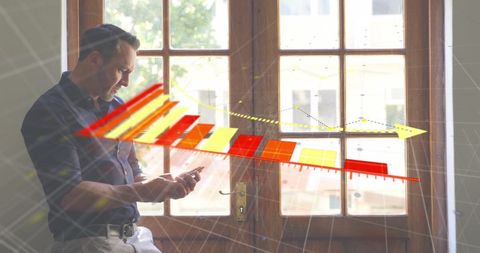 Caucasian Businessman Analyzing Financial Data on Smartphone Indoors