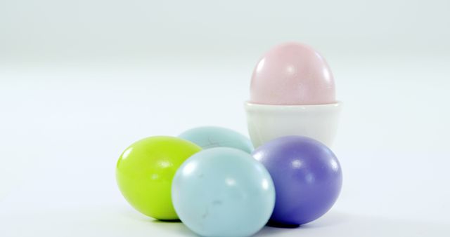 Colorful plastic eggs on a white backdrop hint at Easter celebrations and egg hunts. - Download Free Stock Photos Pikwizard.com