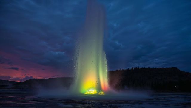Vibrant Geothermal Geyser Erupting at Night