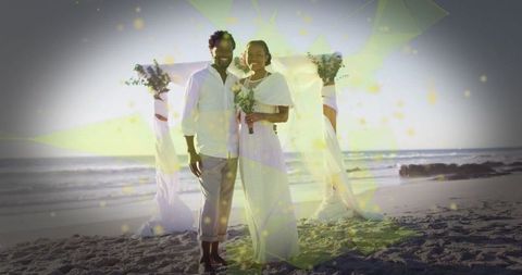 Romantic beach wedding at sunrise with bride and groom
