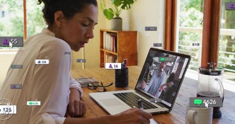 Remote collaboration and note-taking at home desk with laptop and live reaction overlays