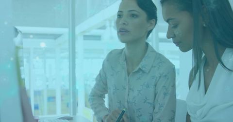 Women Collaborating on Creative Digital Design in Modern Office