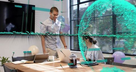 Team collaborating around laptop with digital data visualization overlay in bright workspace