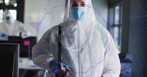Disinfecting office worker wearing full ppe and mask using sprayer with ar overlay