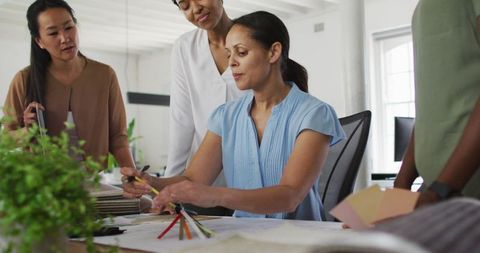 Diverse Businesswomen Collaborating on Project in Modern Office