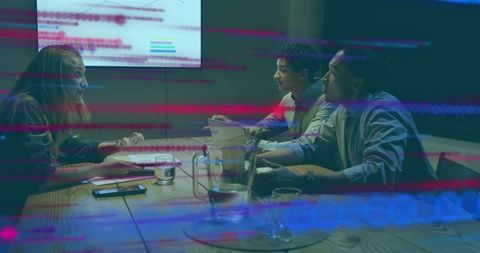 Team reviewing printed documents in moody boardroom with digital glitch overlay